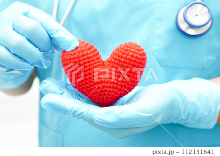 Asian woman doctor holding red heart for health in hospital. 112131641