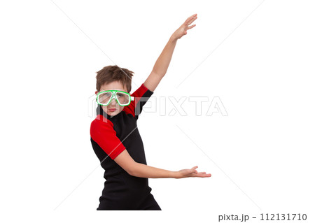 A little boy in a wetsuit and swimming goggles on a white background. 112131710