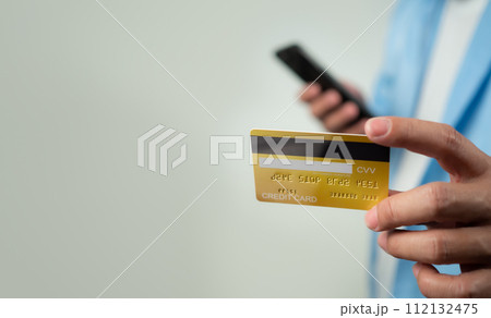 Online payment, Man using mobile smartphone and credit card for online shopping, Digital online payment concept, Technology online banking applications via internet network, financial transaction. Online payment, Man using mobile smartphone and credit card for online shopping, Digital online payment concept, Technology online banking applications via internet network, financial transaction. 112132475