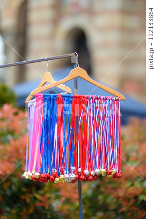 Vrbica orthodox holiday. Small bells, wreaths from willow branches and flowers selling near church. Kids and young girls wearing wreaths. 112133864