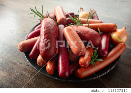 Various sausages with rosemary and onion. 112137312