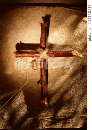 A cross made of sticks is on a table 112138112