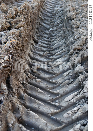 The tire tracks are deep and muddy 112138117