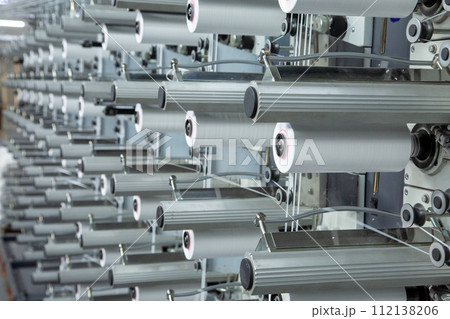A range of equipment with spools of polypropylene threads. A range of equipment with spools of polypropylene threads. 112138206