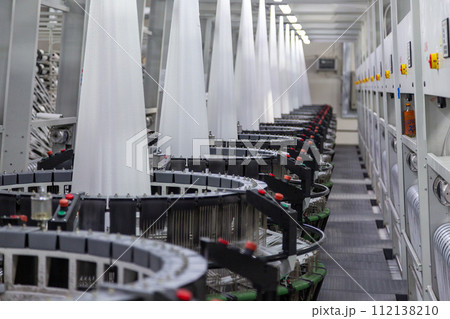 Interior of a factory shop. Equipment for weaving polypropylene fabric. Interior of a factory shop. Equipment for weaving polypropylene fabric. 112138210