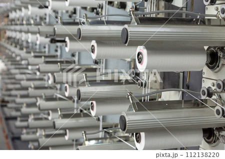 A range of equipment with spools of polypropylene threads. A range of equipment with spools of polypropylene threads. 112138220