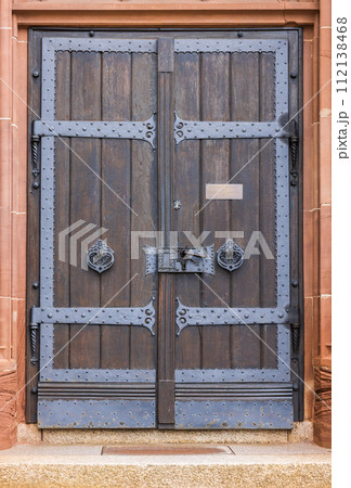wooden door in a brick wall 112138468