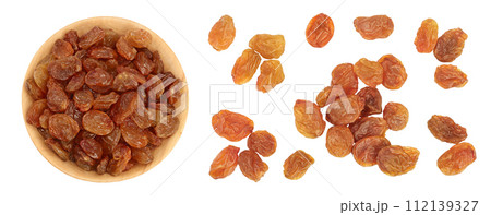 Brown raisins in wooden bowl isolated on white background . Top view. Flat lay Brown raisins in wooden bowl isolated on white background . Top view. Flat lay 112139327