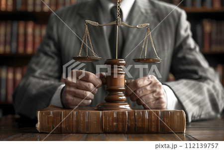 Lawyer with scales of justice in courtroom 112139757