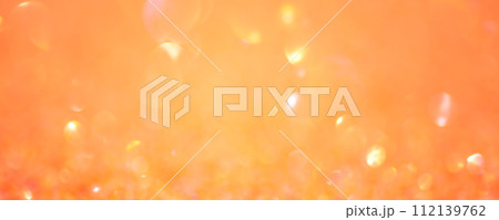 Sparkles defocus light. Orange background and yellow defocus. Background banner size. Sparkles defocus light. Orange background and yellow defocus. Background banner size. 112139762