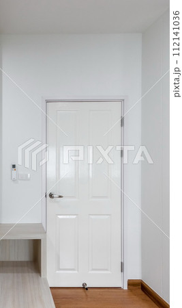 White door in a white room interior 112141036