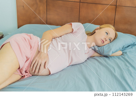 Sleep-deprived pregnant woman struggles with insomnia, navigating the challenges of restlessness during pregnancy 112143269