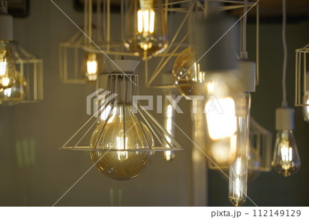 Antique style light bulbs hanging from the ceiling 112149129