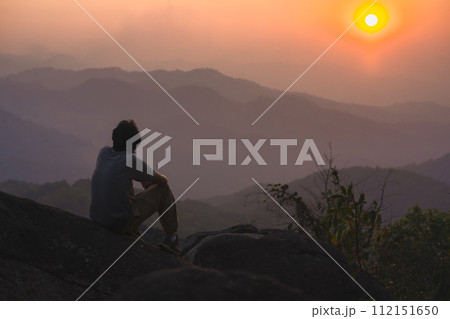 landscape and travel concept with solo freelancer man relax at top of mountain and sunset with layer of mountain 112151650