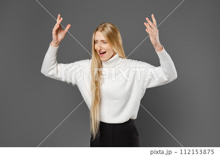 Dissatisfied woman swears and gesticulates emotionally with her hands Dissatisfied woman swears and gesticulates emotionally with her hands 112153875