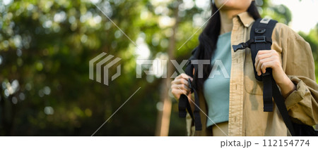 Cropped shot female tourist with backpack hiking at springtime. Travel and active life concept Cropped shot female tourist with backpack hiking at springtime. Travel and active life concept 112154774