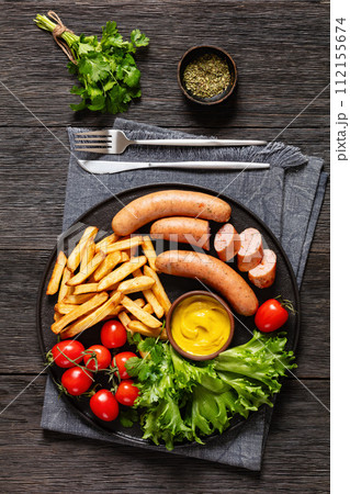 sausages with potato, lettuce, tomatoes, top view 112155674