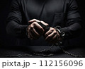 criminal's hands are shackled. bandit in handcuffs. the topic of crime and punishment. 112156096