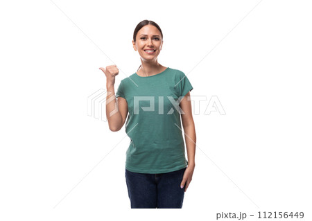 attractive young caucasian woman in a t-shirt points with her index finger 112156449