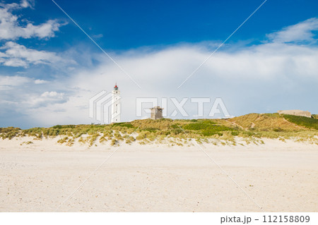 Lighthouse and bunker in the sand dunes on the beach of Blavand, Jutland Denmark Europe 112158809