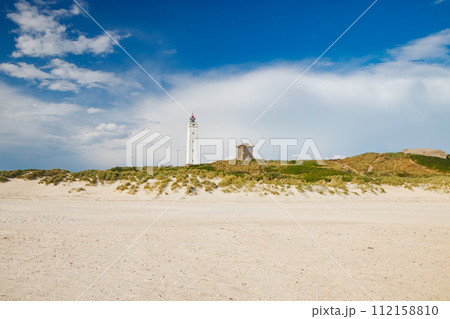 Lighthouse and bunker in the sand dunes on the beach of Blavand, Jutland Denmark Europe 112158810