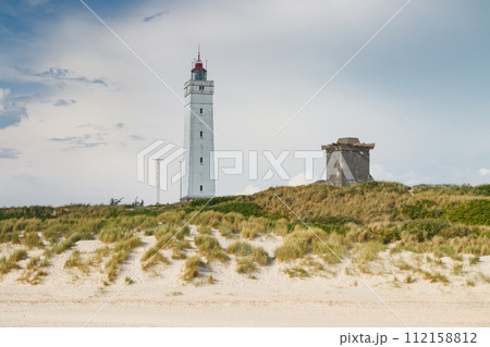 Lighthouse and bunker in the sand dunes on the beach of Blavand, Jutland Denmark Europe 112158812