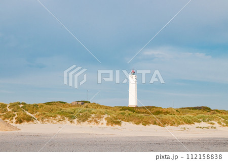 Lighthouse and bunker in the sand dunes on the beach of Blavand, Jutland Denmark Europe Lighthouse and bunker in the sand dunes on the beach of Blavand, Jutland Denmark Europe 112158838