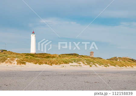 Lighthouse and bunker in the sand dunes on the beach of Blavand, Jutland Denmark Europe 112158839