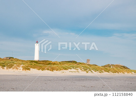 Lighthouse and bunker in the sand dunes on the beach of Blavand, Jutland Denmark Europe 112158840