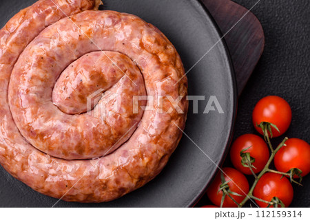 Delicious grilled sausage in the form of a ring with salt, spices and herbs Delicious grilled sausage in the form of a ring with salt, spices and herbs 112159314