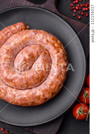 Delicious grilled sausage in the form of a ring with salt, spices and herbs 112159317