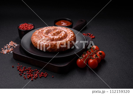 Delicious grilled sausage in the form of a ring with salt, spices and herbs Delicious grilled sausage in the form of a ring with salt, spices and herbs 112159320