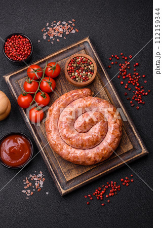 Delicious grilled sausage in the form of a ring with salt, spices and herbs Delicious grilled sausage in the form of a ring with salt, spices and herbs 112159344