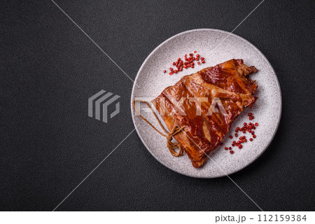 Delicious smoked or grilled ribs with olives, spices and herbs 112159384