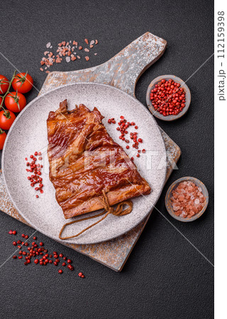 Delicious smoked or grilled ribs with olives, spices and herbs Delicious smoked or grilled ribs with olives, spices and herbs 112159398