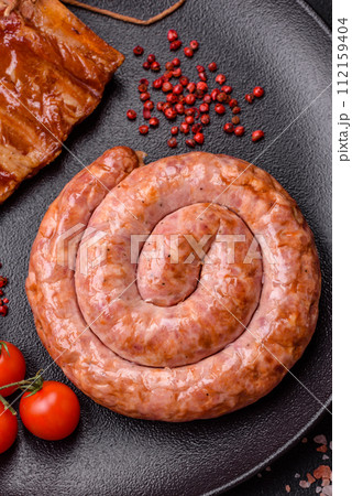 Delicious grilled sausage in the form of a ring with salt, spices and herbs Delicious grilled sausage in the form of a ring with salt, spices and herbs 112159404