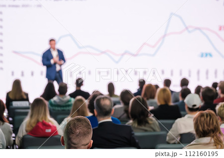 Businessman presenting data growth at corporate conference to audience 112160195
