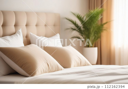 Clean bed. Light bedroom. Modern apartment interior. White sheet, soft pillow, blanket and bedside table. Home, hotel stylish design. Comfortable grey bedding set closeup. Spa resort ad. Rent business 112162394