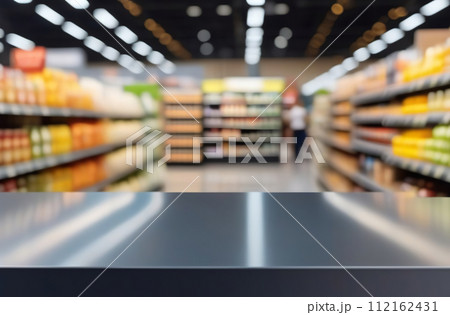 Empty table top with supermarket blurred defocused panorama, bokeh light. Backdrop for display or montage products. Blank gray steel counter with blur grocery, market store background. Front view 112162431