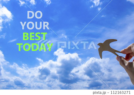 Do your best today symbol. Concept words Do your best today. Beautiful blue sky cloud background. Voter hand with wooden bird. Business motivational do your best today concept. Copy space. 112163271