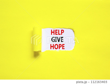 Help give hope symbol. Concept word Help give hope on beautiful white paper. Beautiful yellow table yellow background. Business motivational help give hope concept. Copy space. 112163403