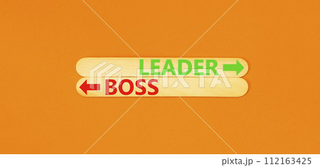 Leader or boss symbol. Concept word Leader or Boss on beautiful wooden stick. Beautiful orange table orange background. Business and leader or boss concept. Copy space. Leader or boss symbol. Concept word Leader or Boss on beautiful wooden stick. Beautiful orange table orange background. Business and leader or boss concept. Copy space. 112163425