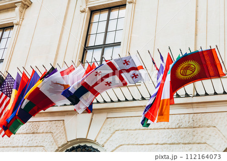 National flags of various countries flying in the wind. Colorful flags from different countries. Flags Organization for Security and Co-operation in Europe 112164073