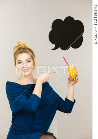 Happy woman holding fresh orange juice Happy woman holding fresh orange juice 112166141