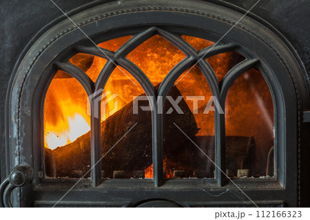 Closeup of burning fire wood in home fireplace. 112166323