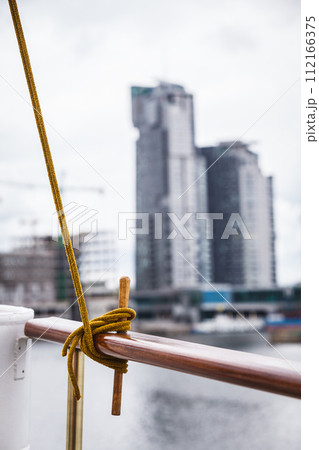 Rope tied around hook on handrail 112166375