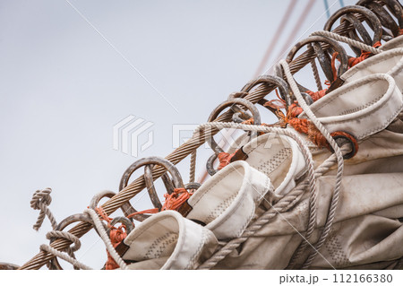 Detailed closeup of mast rigging on sail boat 112166380