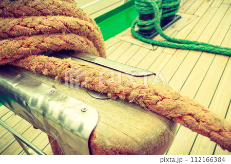 Old fashioned harbor marina sailboat ropes Old fashioned harbor marina sailboat ropes 112166384