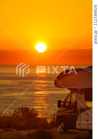 Caravan on sea at sunrise. 112166626