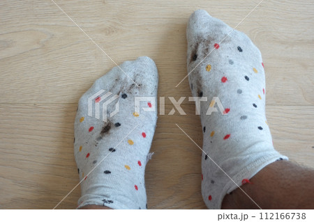 men feet with dirty socks while sitting on sofa men feet with dirty socks while sitting on sofa 112166738
